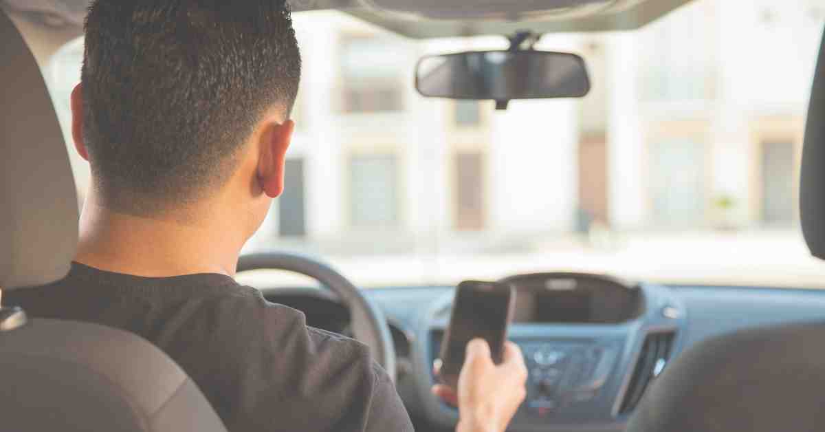 young man texting and driving